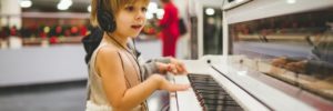 A young girl plays the piano at a music class in Alpharetta, Georgia