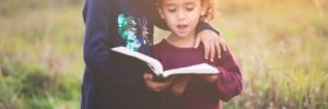 Two girls read out of a book from their language class in Cedar Park, Texas