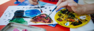 A child painting at a mommy and me class in Centennial, Colorado