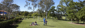 A family enjoys a sunny day at Frisco Commons Park in Frisco, Texas
