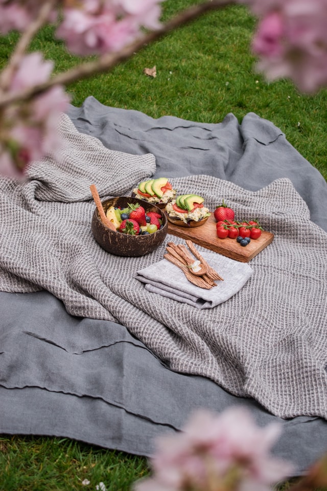 Cooked food is prepared and laying on a blanket for a picnic in Cedar Park, Texas