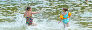 Two kids play in a lake in Maple Grove, Minnesota