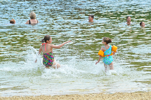 Two kids play in a lake in Maple Grove, Minnesota