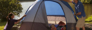Family setting up a tent