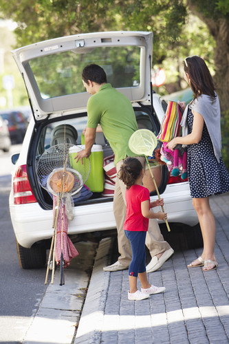 A family unpacks their vehicle as they arrive on their day trip from Ellisville, Missouri