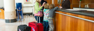 Parents and their child check in at a hotel for a family staycation in Lone Tree, Colorado