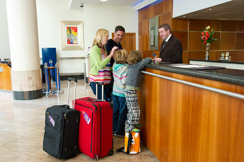 Parents and their child check in at a hotel for a family staycation in Lone Tree, Colorado