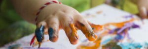 A child takes a finger painting class at a kids art local club in Alpharetta, Georgia