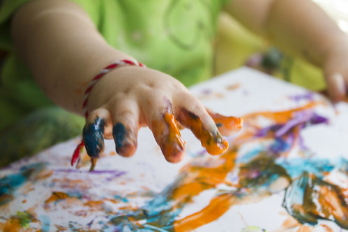 A child takes a finger painting class at a kids art local club in Alpharetta, Georgia