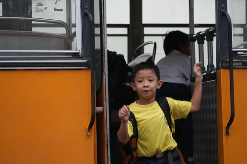 A boy runs off the bus to his first day of school after moving to Thornton, Colorado