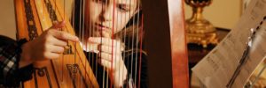 A girl plays the harp at a music class in Romeoville, Illinois