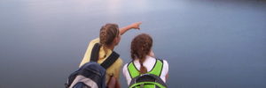 Two girls enjoy the view from the peak of a hike in Centennial, Colorado