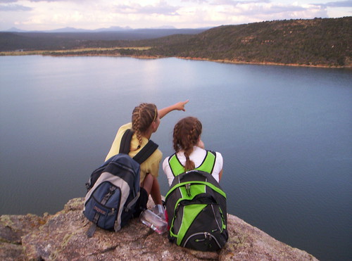 Two girls enjoy the view from the peak of a hike in Centennial, Colorado