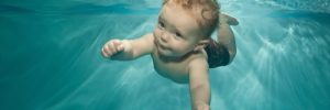 A child swims at the local indoor pool as a rainy day activity in McKinney, Texas