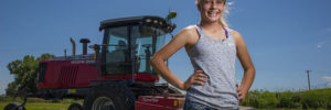 A farmer stands behinds her tractors as she prepares food for CSA boxes in Warrenville, Illinois