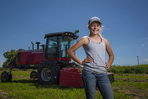 A farmer stands behinds her tractors as she prepares food for CSA boxes in Warrenville, Illinois