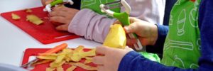 Children peel potatoes at a kids cooking class in Colleyville, Texas