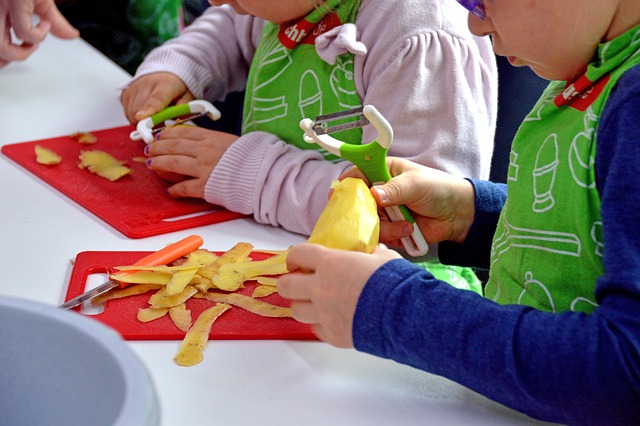 Children peel potatoes at a kids cooking class in Colleyville, Texas