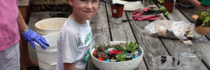 A child learns how to plant a low-maintenance garden in West Chester, Ohio