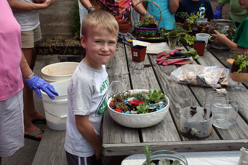 A child learns how to plant a low-maintenance garden in West Chester, Ohio