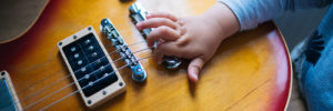 A child learns to play the guitar at a kids music class in Goodyear, Arizona