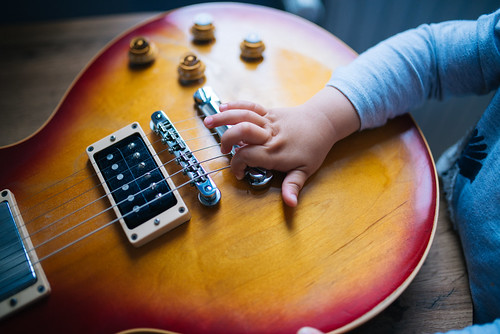 A child learns to play the guitar at a kids music class in Goodyear, Arizona