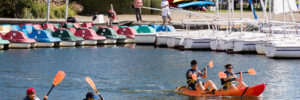 A family kayaks down a waterway in Chandler, Arizona