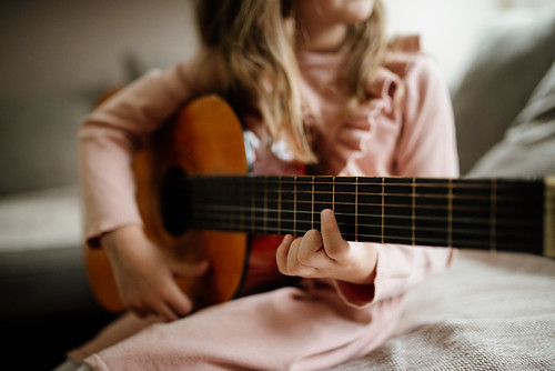 Little girl practicing her guitar.