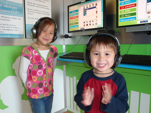 Two children using audio headsets to take a language class.