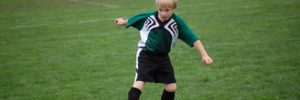 Small boy playing organized soccer.
