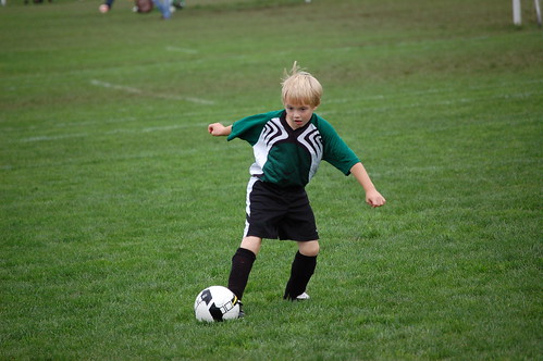 Small boy playing organized soccer.