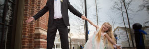Man and daughter dressed up and holding hands posed for a picture
