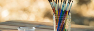 Image of some paint brushes in a cup.