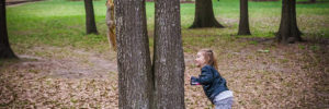 Small child chasing a squirrel in a park.
