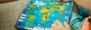 Image of a child examining a toy map.