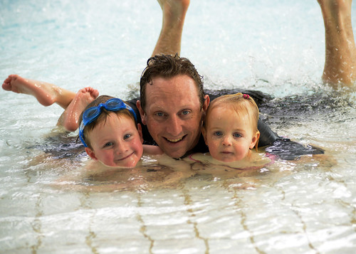Father and two children enjoying a day at a waterpark.