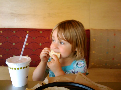 Small girl eating a restaurant Quesadilla.