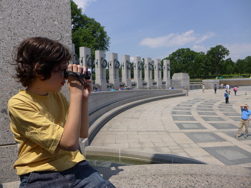 Kid using binoculars at an Ashburn, VA monument.