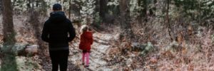 Image of a father and daughter walking a nature trail in Mt. Airey Forest.