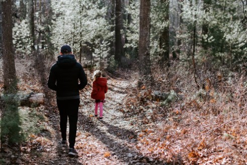 Image of a father and daughter walking a nature trail in Mt. Airey Forest.