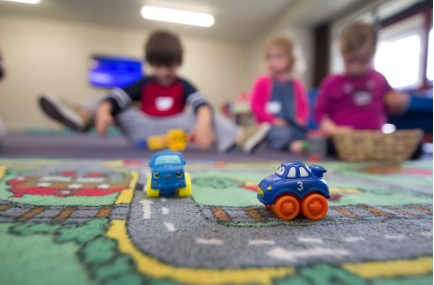 Image of children playing with toys in a preschool.