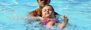 Child and mother learn to swim at a Peoria, AZ pool.