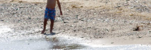 A small boy playing on a beach in Glenview, IL.