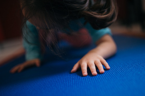 Small child practicing yoga.