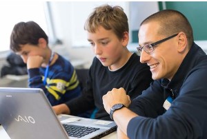 Three boys sit at computer and learn to code in Coppell, TX class.