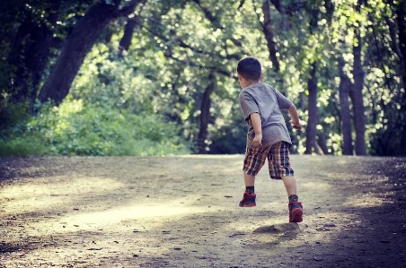 A small boy running on a hiking trail in Centennial, CO.