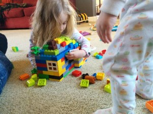 Two children playing with blocks in daycare.