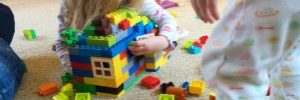 Two children playing with blocks in daycare.