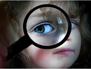 Children holding eye glass in front of their face.