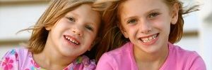 Two young girls smile in Leawood, KS.
